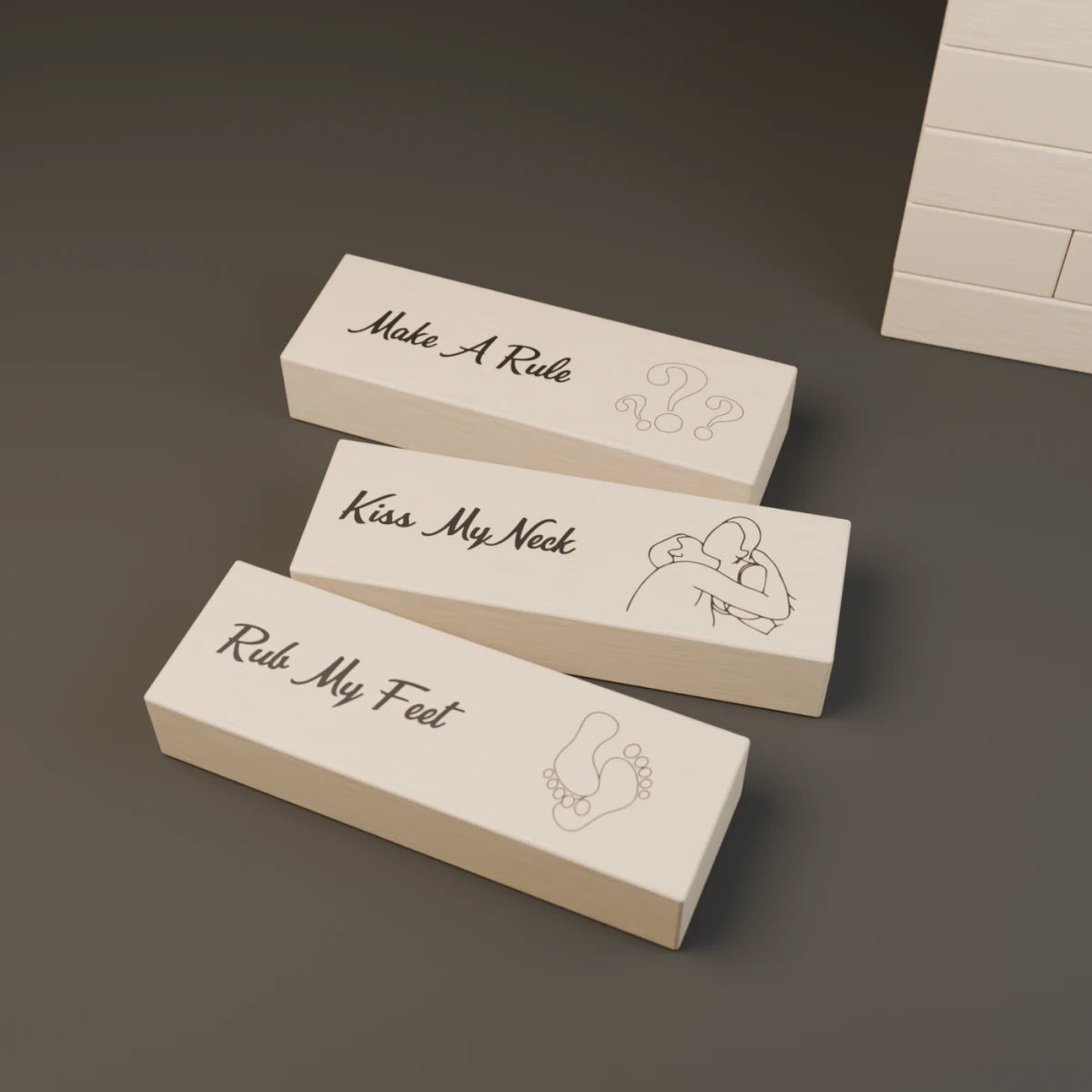 Three wooden Tease Tower blocks showing the original Rub My Feet, Kiss My Neck and Make A Rule artwork